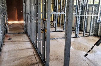 Narrow hallway framed with metal studs