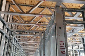 Metal and wooden framework in a construction site ceiling.