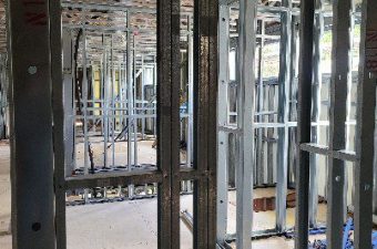 Metal framing for walls inside a building under construction.