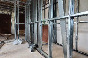 Metal framing studs installed for wall construction in a building.