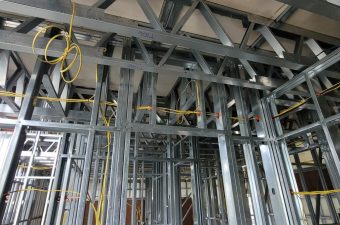 Metal framework of a building under construction with electrical wiring in place.