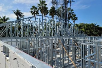 Metal framing with palms and tower
