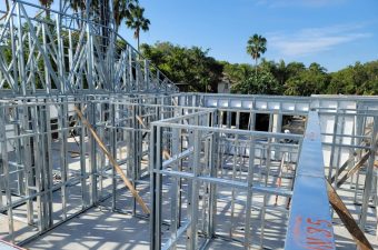 Metal framework for a building under construction on a sunny day.