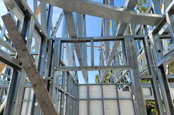 Steel framework under construction on a sunny day.