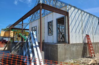 Steel framework and concrete foundation for a building under construction.
