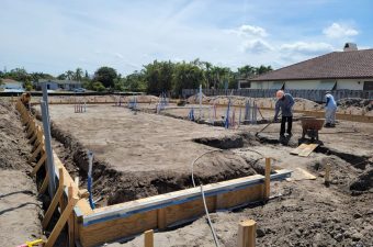 Construction site with workers preparing foundation for a building.
