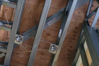 Metal ceiling framework with electrical boxes installed.