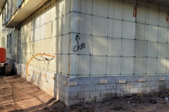 Construction site with exposed wall insulation and wiring.
