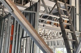 Metal framing and stairs under construction inside a building.