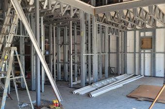 Interior view of metal framing studs in a building under construction.