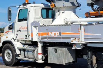 Close-up of a white industrial truck with equipment and MPC branding.
