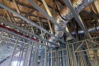 Metal framework and ductwork inside a building under construction.