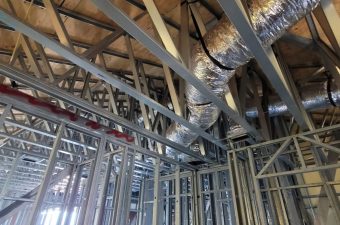 Metal framework and ductwork inside a building under construction.