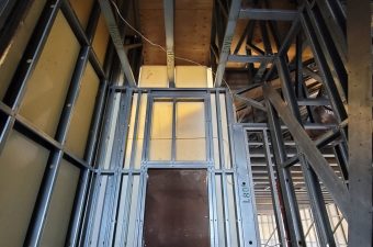 Metal framing and wooden beams in a building under construction.
