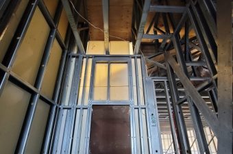 Metal framing and wooden beams in a building under construction.