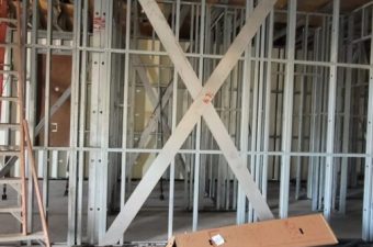 Interior wall framing with metal studs and braces in construction.