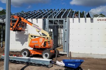 Construction site with solar panels and machinery.