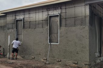 A building wall under construction with a window and scaffolding.