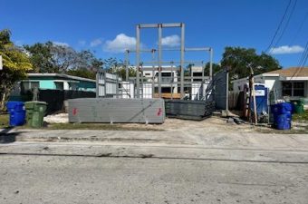 Construction site with building framework under clear sky.