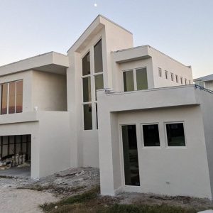 White contemporary beachfront house with tall central windows