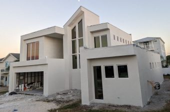 White contemporary beachfront house with tall central windows