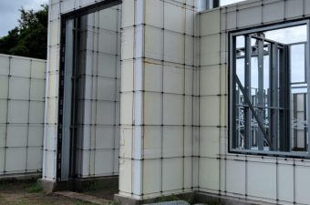 Unfinished building with concrete block walls and window frames.