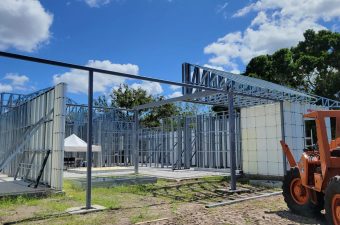Construction site with orange lift and trusses
