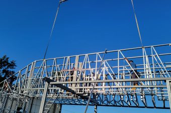 Crew working on elevated metal framing