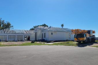 A house under construction with a clear blue sky.