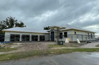 Construction site of a building under cloudy skies.