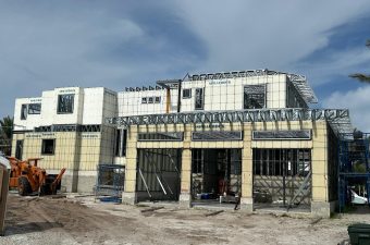 A partially constructed building with a cloudy sky above.