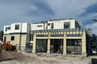 A partially constructed building with a cloudy sky above.