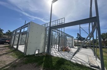 Steel building frame under sunny blue sky