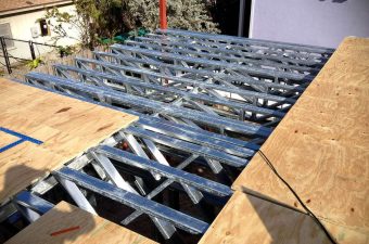 Metal trusses forming the framework for a roof under construction.