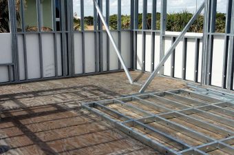 Steel frame structure under construction with metal studs and braces.