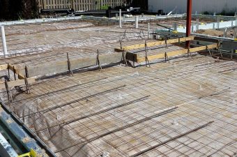 Concrete foundation with steel reinforcement bars ready for pouring.