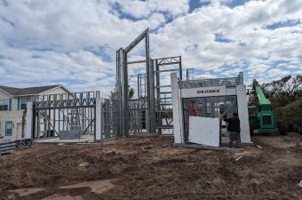 Industrial gas or fluid control station with pipes and valves under construction.