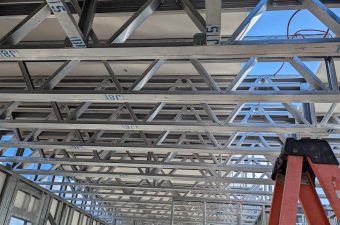 Metal framework and ladder inside a building under construction.