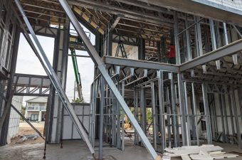 Steel framing structure under construction at a building site.