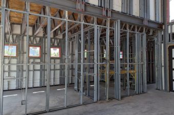 Interior framing of a building under construction with exposed metal studs.