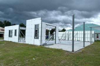 Partially constructed building under a cloudy sky.